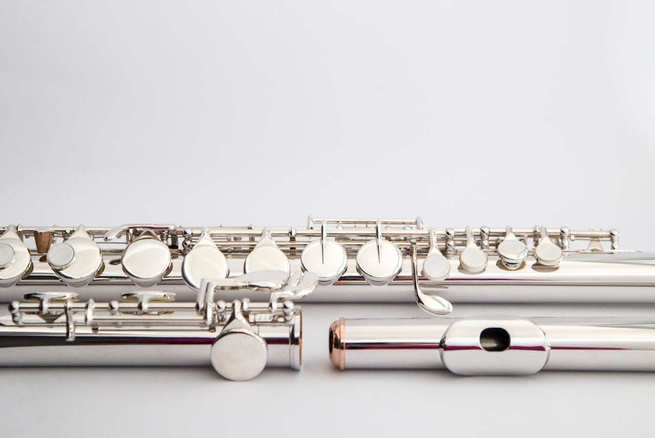 Detailed shot of elegant silver flutes showcasing musical craftsmanship and design.